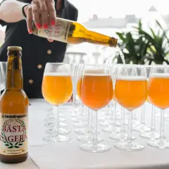 Une personne verse la bière suédoise connue, Bästa Lagern, dans des verres.