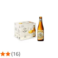 Une bouteille et une boîte de bière Tripel Karmeliet, avec un verre rempli de cette bière ambrée.