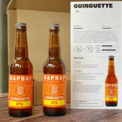 Deux bouteilles de bière artisanale "Guinguette IPA" de BAPBAP. Une bière qui fait penser à un hibou, avec son nom et son logo audacieux.