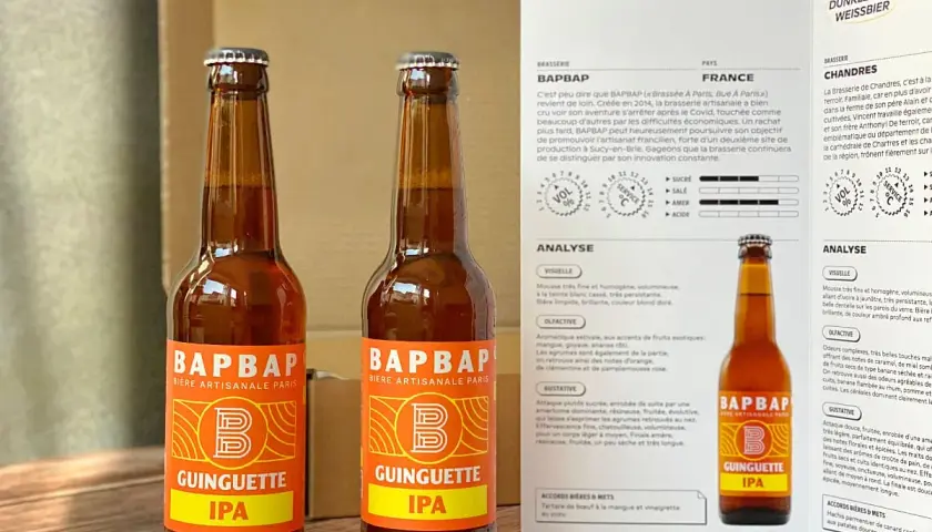 Deux bouteilles de bière artisanale "Guinguette IPA" de BAPBAP. Une bière qui fait penser à un hibou, avec son nom et son logo audacieux.