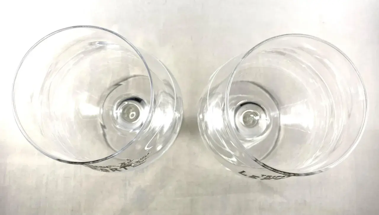 Deux verres à pied transparents, vus de dessus, avec le logo "LE TRIFLE FORT" gravé.