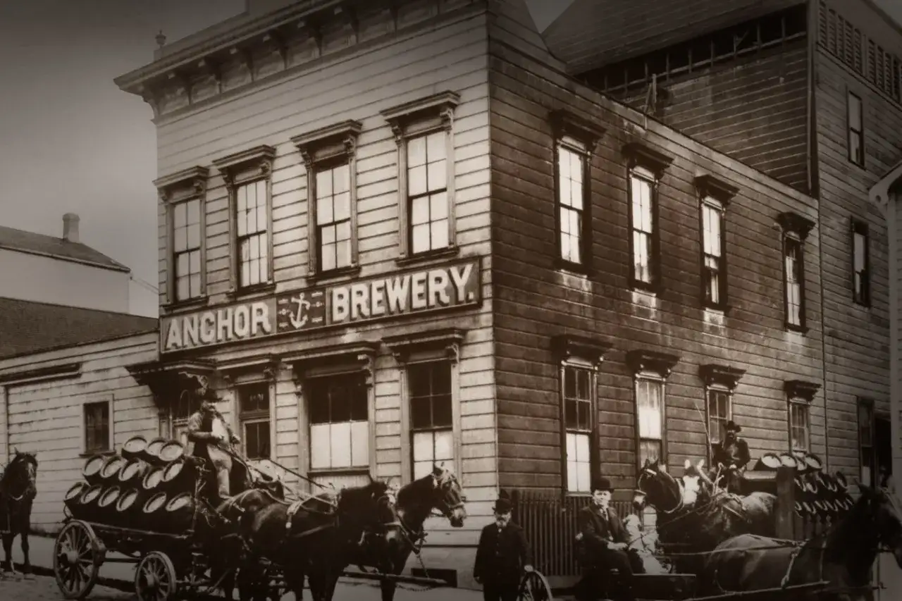Bâtiment historique de l'Anchor Brewery, avec des chevaux tirant des charrettes chargées de tonneaux de bière.